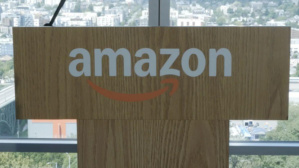 Amazon logo on wooden podium with city skyline behind